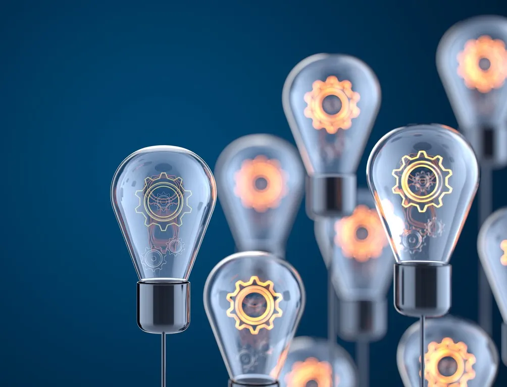 Multiple glowing lightbulbs with gear mechanisms inside against dark blue background