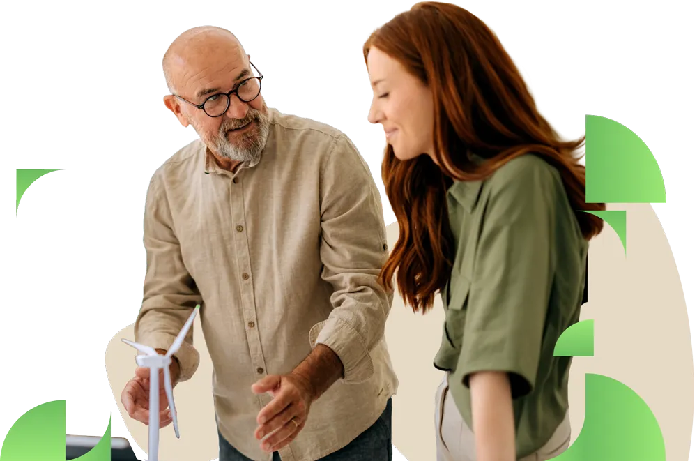 Two people gathered around a desk reviewing papers and having a collaborative discussion