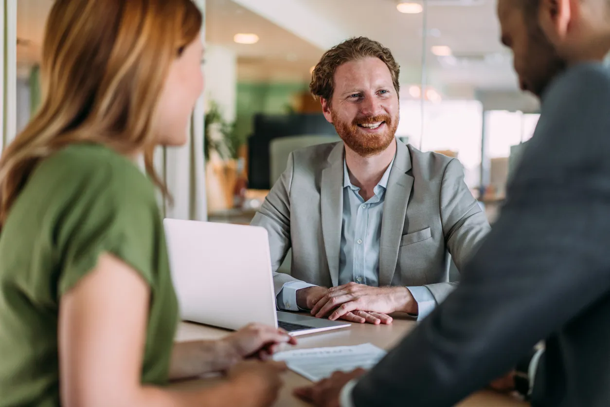 Smiling man in a business meeting with two colleagues