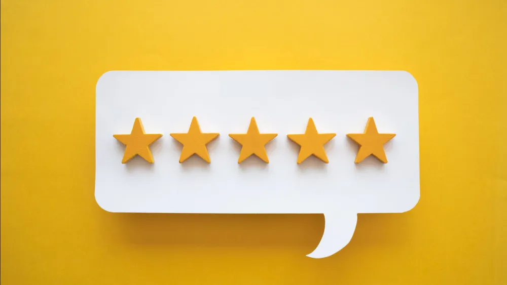 5 gold stars in speech bubble with orange background