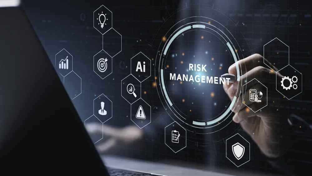 Person interacting with transparent digital risk management interface above laptop