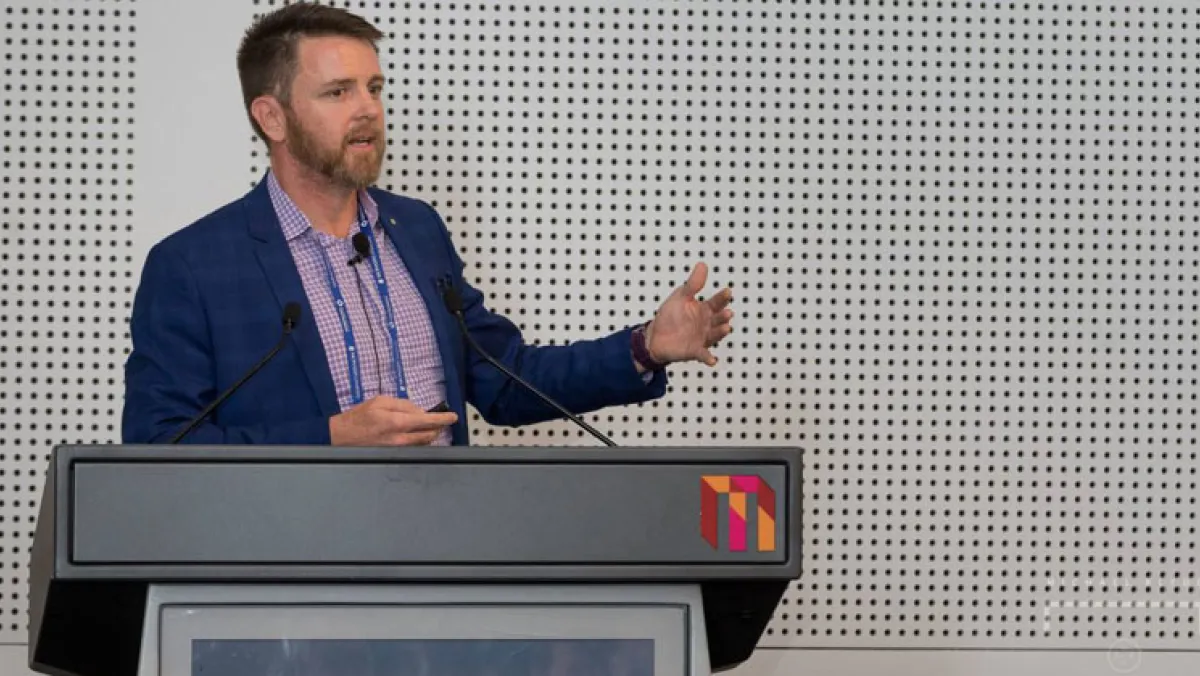 Man on a podium giving an address